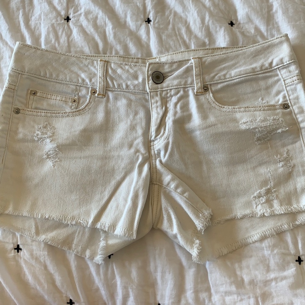 White distressed denim cutoffs American Eagle.